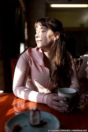 A pink latex hoodie in a café'